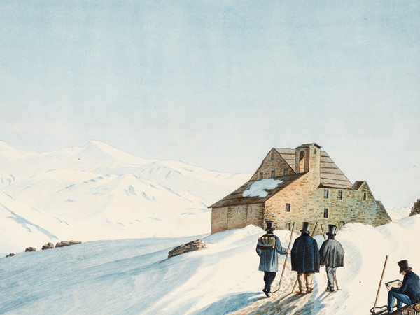 Tre turisti davanti all’ospizio del Gottardo sulla strada innevata lungo il passo del San Gottardo.